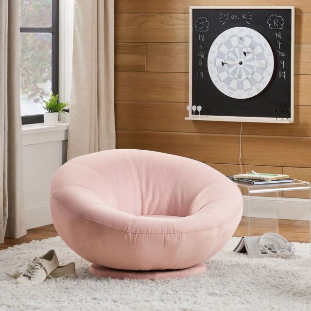 pink swivel chair by a window