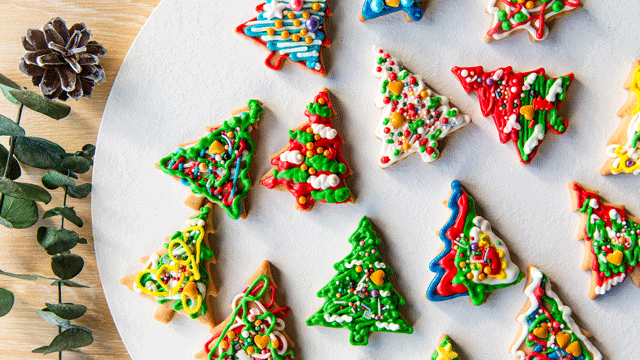 Colorful Christmas cookies are shaped and decorated to look like trees
