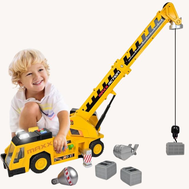 little boy playing with a crane toy