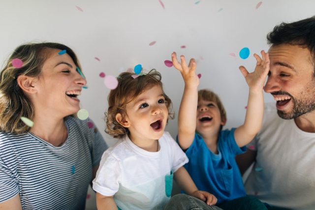 tossing confetti is a fun New Year's Eve party idea for kids