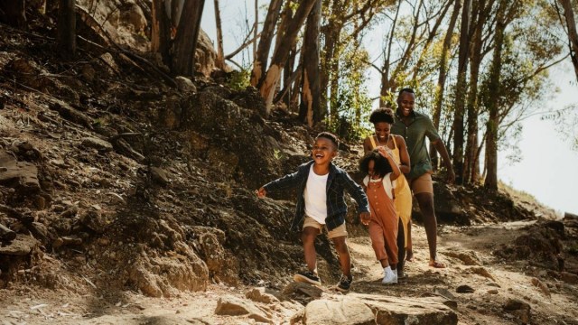 a young boy runs ahead of his family on a trail, best hikes near atlanta is what they're looking for