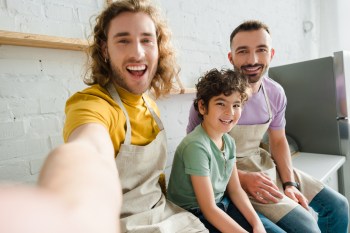 same sex couple with son pride month events