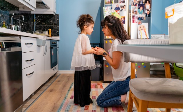 little girl being spoken to sternly at home by her mother