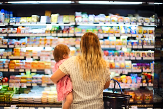 Mom holding child in grocery store