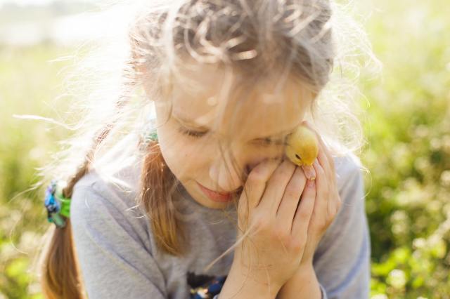 girl holding duckling