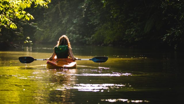 girl checking kayaking off her list of outdoor adventures 