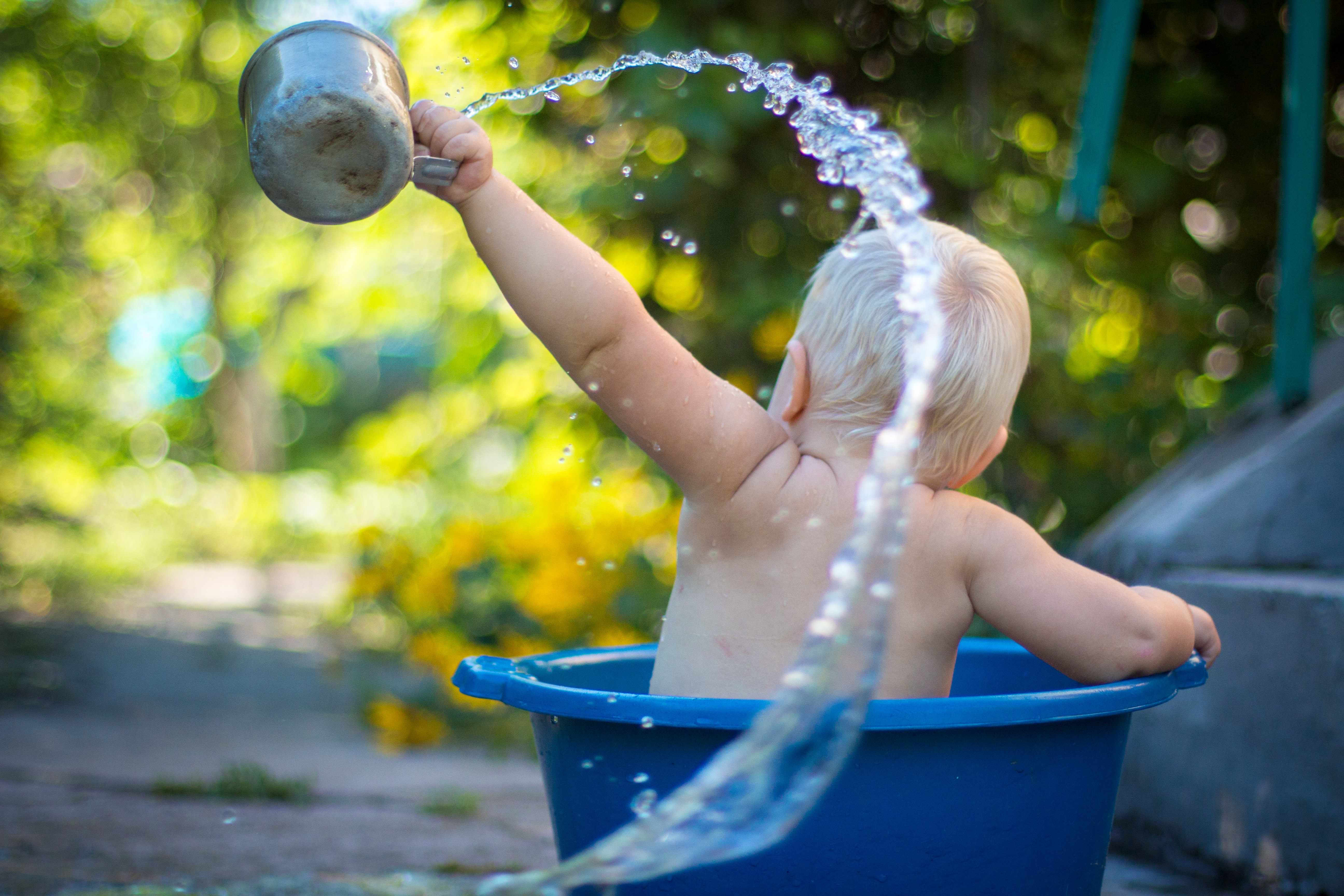 baby playing in water which is a good summer sensory activity
