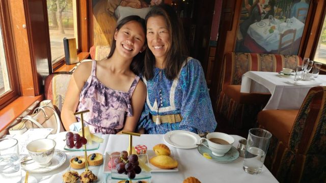 A mother and daughter enjoy afternoon tea on the Napa Valley Wine Train