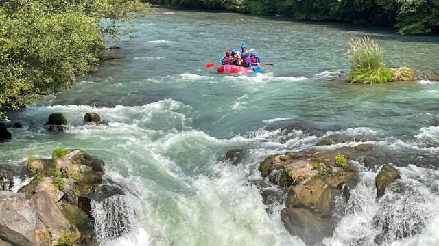 a raft sits on the edge of a rapid, ready to go over in washington white salmon river