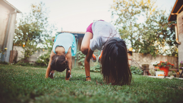 two little girls enjoying backyard hacks in the summer