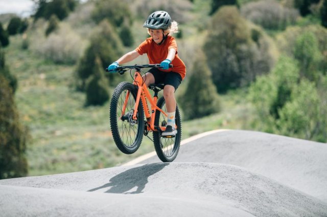 A kid rides a mountain bike