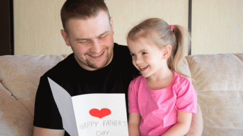 father and daughter reading father's day card