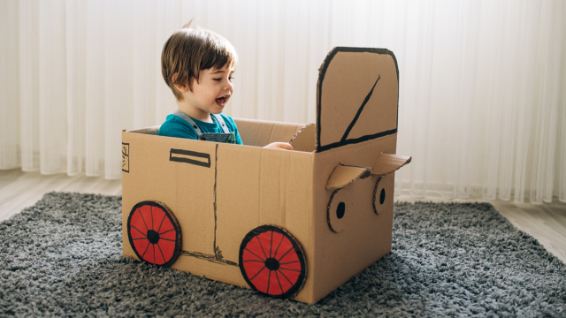 little boy in a cardboard box craft