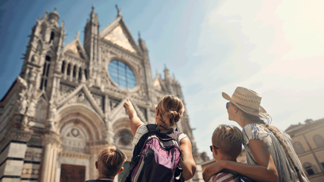 family looking at church in europe on family vacation