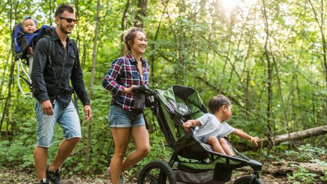 a family hikes and backpacks through the woods