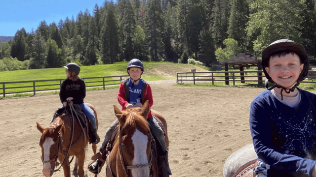 kids on horseback ride at dude ranch