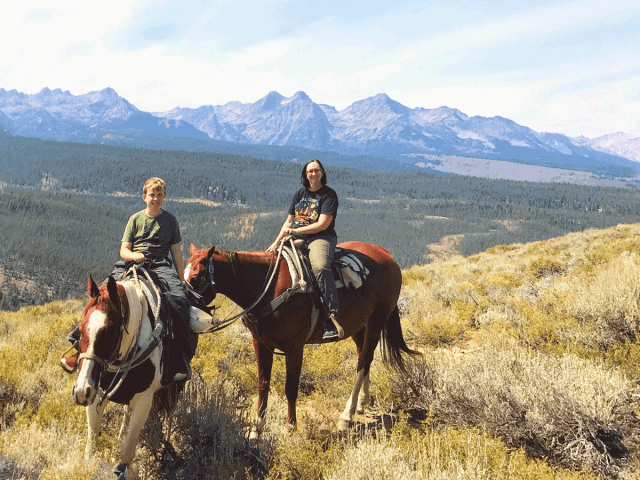 Family horseback riding at dude ranch Idaho Rocky Mountain Ranch