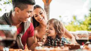 family eating outside on a patio