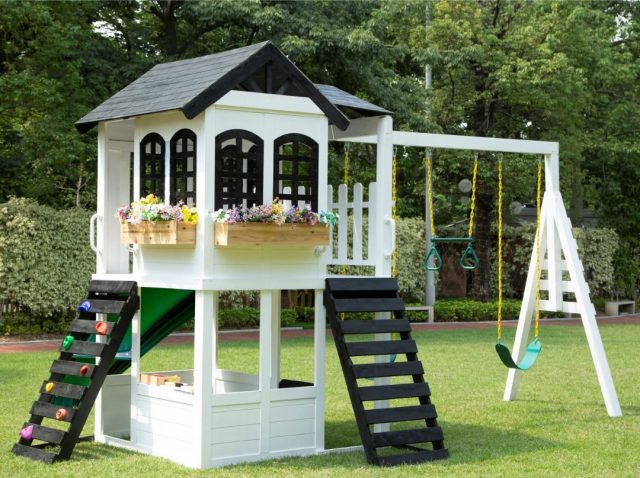 two story playhouse with swingset