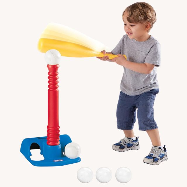 child playing with t-ball set