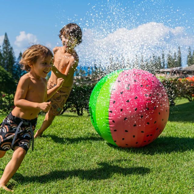 kids running around inflatable watermelon sprinkler