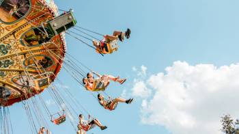 people fly through the air on carnival swings at a fall festivals and fairst