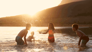 Kids playing in lake in summer