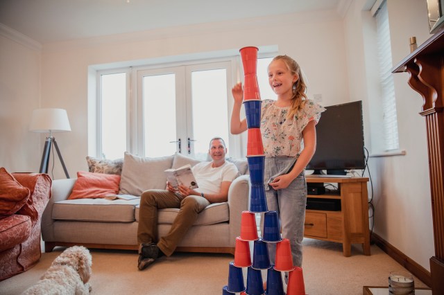 girl playing the stacking cup minute to win it game