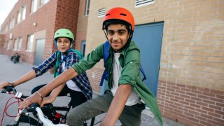 two boys wearing helmets that know how to make smart decisions