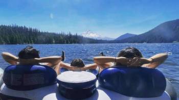 a family floats with mt hood in the distance at a portland swimming holes and lakes resort