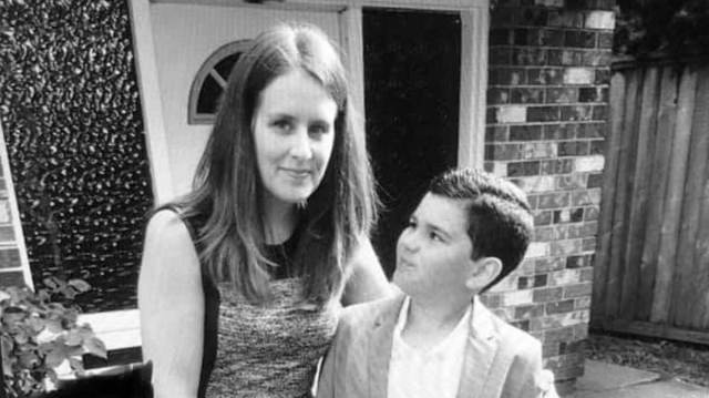mom stands with son with autism