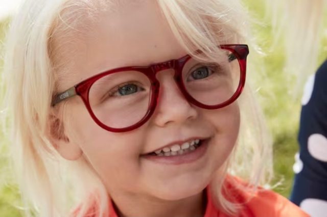 blonde toddler wearing red eyeglasses
