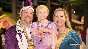 a family of three dressed as a royal family at a halloween event in atlanta at the childrens museum