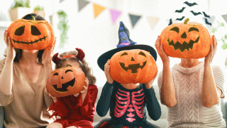 Four kids celebrate Halloween with jack-o-lanterns and Halloween jokes for kids