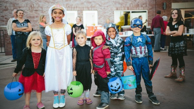 a group of kids ready to go trick or treating in portland in costumes