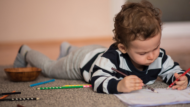 little boy enjoying coloring pages for toddlers