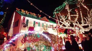 The Menashe house in West seattle covered in tiny lights for the holidays is a long-standing traditional Seattle Christmas lights display