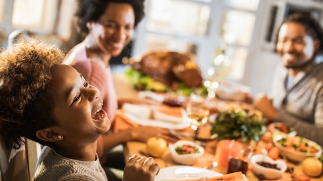 a boy and his family enjoying thanksgiving dinner in portland at a restaurant that's open on Thanksgiving