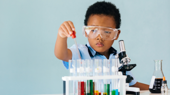 little boy using a science toy