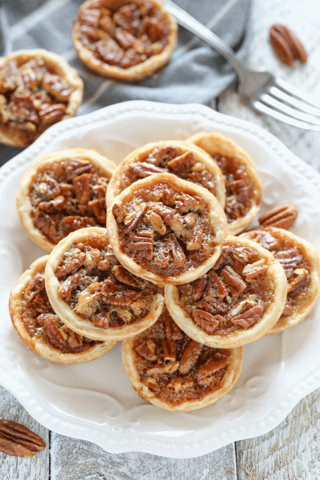 A plate filled with mini pecan pies, meant to replace your traditional Thanksgiving pie