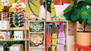 Colorful costumes and fairy wings line the shelves of toy store portland Hammer and Jacks
