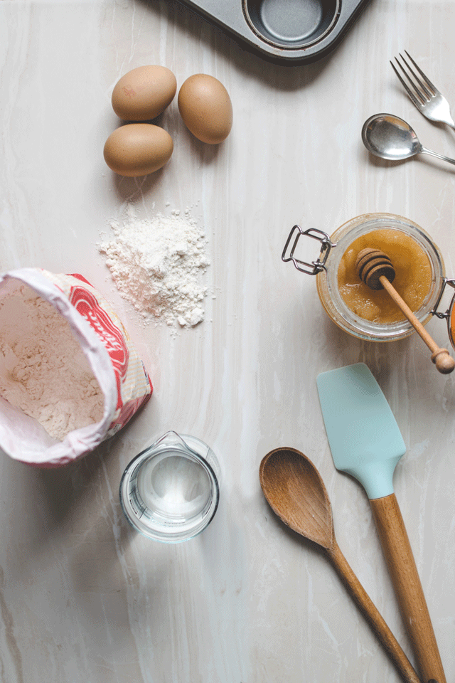Baking ingredients, bowls and spoons sit on a table waiting for you to use some baking hacks