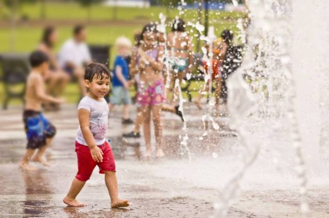 A boy plays at a splash park