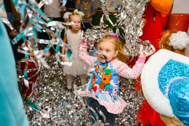Kids play with tinsel at a birthday party