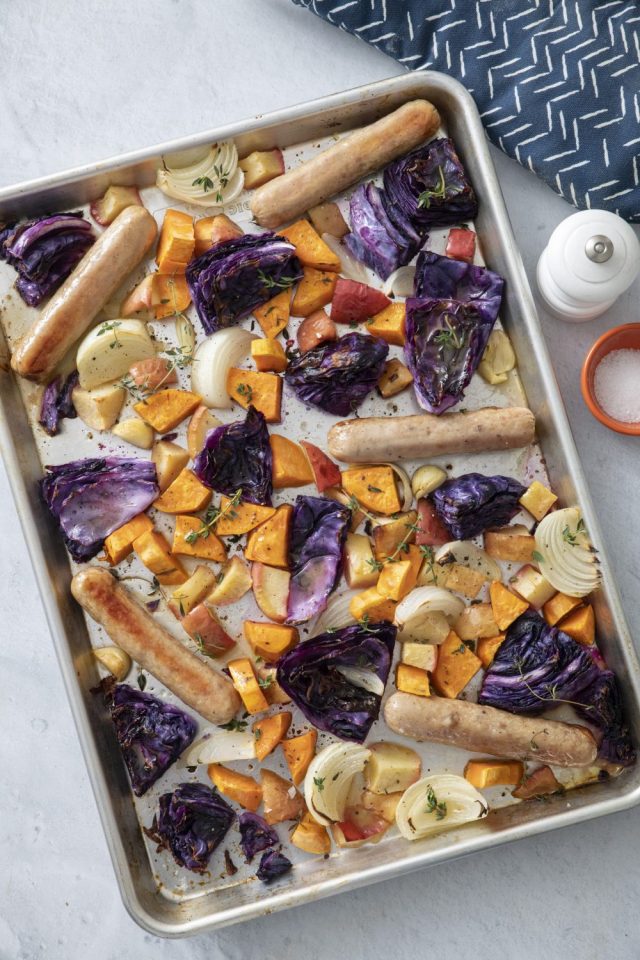 Sheet Pan Sausage with Cabbage and Apples on a cooking sheet ready to be served