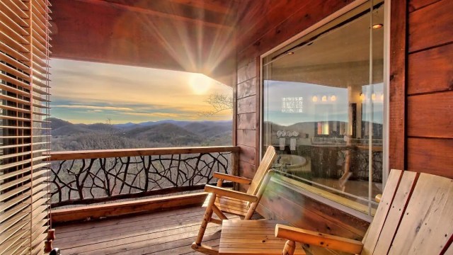 a sunset from a porch at a luxury mountain rental cabin near atlanta