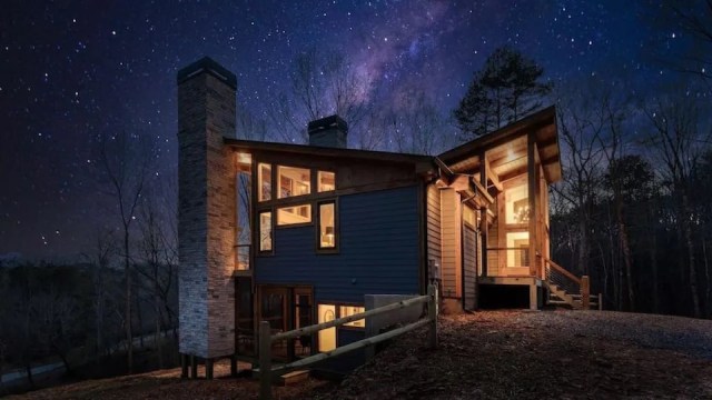 a vivid night sky behind a modern cabin rentals near Atlanta ga