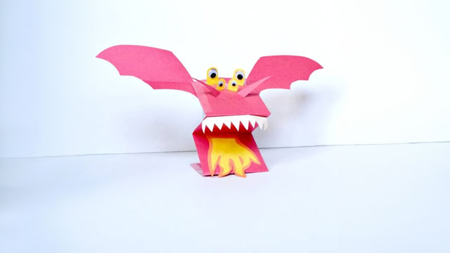 a picture of a cute dragon hand puppet