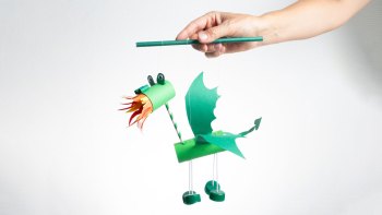 a hand holding a dragon craft made at home
