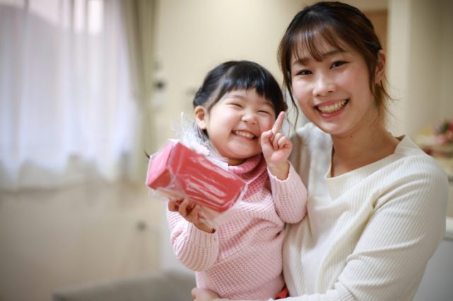 A mom and daughter smile as they celebrate Mother's Day